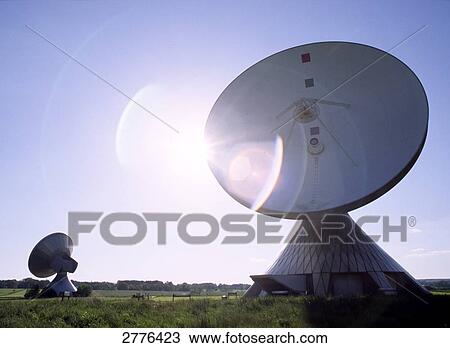 Stock Image - Satellite dishes on landscape . Fotosearch
