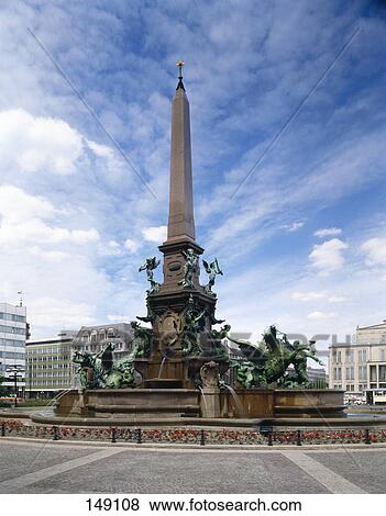 Sculptures at water fountain in city square, Augustus Square, Leipzig, Saxony, Germany View Large Photo Image Stock Photo - Sculptures at water fountain in city square, Augustus Square, Leipzig, Saxony, Germany . Fotosearch