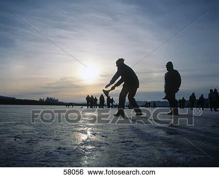 Silhouette of people playing curling on frozen lake, Lake Chiemsee, Upper Bavaria, Bavaria, Germany View Large Photo Image Stock Photograph - Silhouette of people playing curling on frozen lake, Lake Chiemsee, Upper Bavaria, Bavaria, Germany . Fotosearch