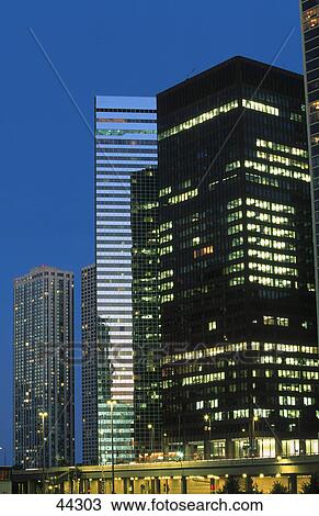Stock Image - Skyscrapers in city lit up at night, Wacker Drive, Michigan Avenue, Chicago, Illinois, USA . Fotosearch