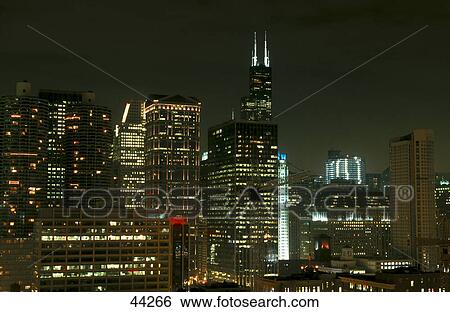 Stock Photograph - Skyscrapers in city lit up at night, Sears Tower, Chicago, Illinois, USA . Fotosearch