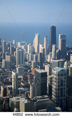 Stock Image - Skyscrapers in city with lake in background viewed from Sears Tower, John Hancock Center, Lake Michigan, Chicago, Illinois, USA . Fotosearch