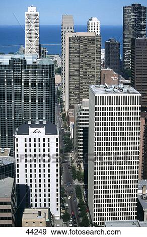 Stock Photo - Skyscrapers in city with lake in background, Chicago, Lake Michigan, Illinois, USA . Fotosearch