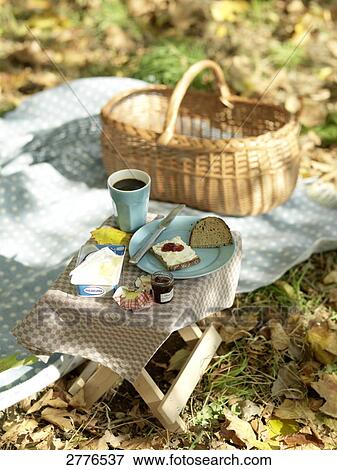 Slice of bread with jam and coffee cup on table in park View Large Photo Image Stock Photo - Slice of bread with jam and coffee cup on table in park . Fotosearch