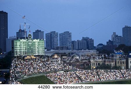Spectators watching baseball game in stadium with city skyline in background, Wrigley Field, Chicago, Illinois, USA View Large Photo Image Stock Image - Spectators watching baseball game in stadium with city skyline in background, Wrigley Field, Chicago, Illinois, USA . Fotosearch