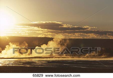Steam emitting from lake at dusk, Yellowstone Lake, Yellowstone National Park, Wyoming, USA View Large Photo Image Stock Photo - Steam emitting from lake at dusk, Yellowstone Lake, Yellowstone National Park, Wyoming, USA . Fotosearch