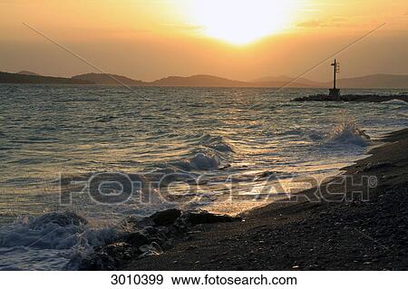 Stock Photo - Sunset at the beach of Sibenik, Croatia . Fotosearch
