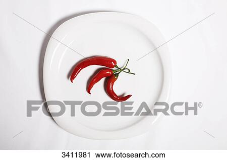 Three chillies on a white plate View Large Photo Image Stock Image - Three chillies on a white plate . Fotosearch