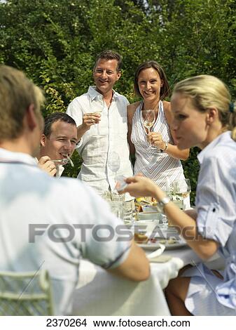 Picture - Three couples celebrating at a garden party . Fotosearch