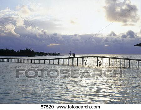 Three people standing on a bridge, Maldives View Large Photo Image Stock Image - Three people standing on a bridge, Maldives . Fotosearch