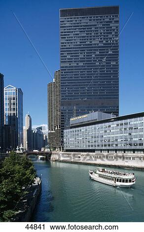 Stock Image - Tourboat in river with IBM and Chicago Sun-Times buildings in city, Chicago, Illinois, USA . Fotosearch