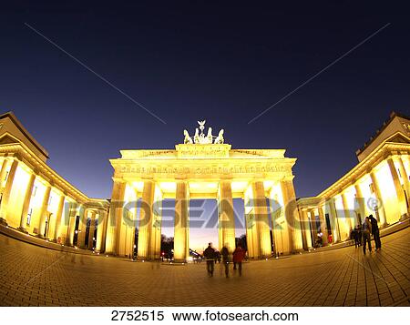 Stock Photography - Tourists at monument lit up during dusk, Brandenburg Gate, Berlin, Germany . Fotosearch