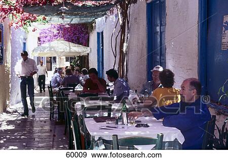 Stock Photo - Tourists at outdoor cafe, Nafplio, Peloponnesus, Greece Tourists at outdoor cafe, Nafplio, Peloponnesus, Greece . Fotosearch