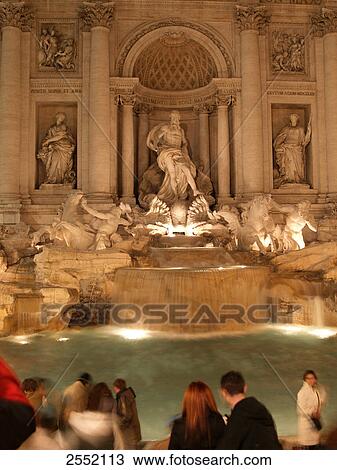 Stock Image - Tourists standing in front of fountain . Fotosearch