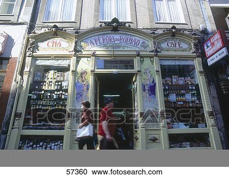 Stock Image - Tourists walking in front of restaurant, Azulejo, Portugal . Fotosearch