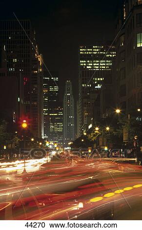 Traffic moving on road in city, Water Tower Place, Chicago, Illinois, USA View Large Photo Image Stock Image - Traffic moving on road in city, Water Tower Place, Chicago, Illinois, USA . Fotosearch