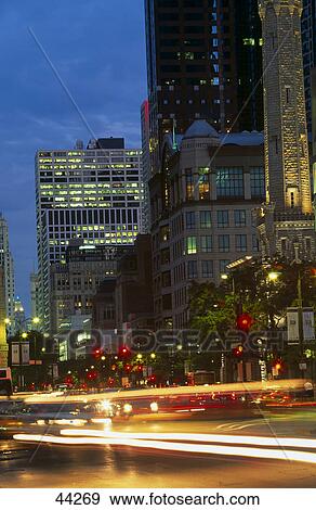 Traffic moving on road in city, Water Tower Place, Chicago, Illinois, USA View Large Photo Image Stock Photo - Traffic moving on road in city, Water Tower Place, Chicago, Illinois, USA . Fotosearch