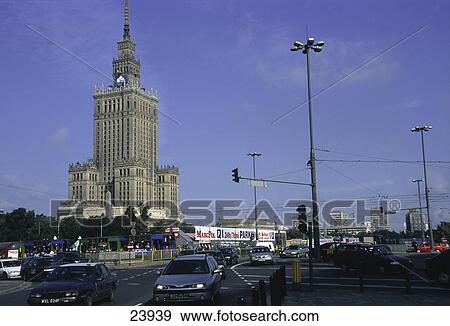 Stock Photo - Traffic on the road in a city with a tower in background, Palace of Culture, Warsaw, Poland . Fotosearch