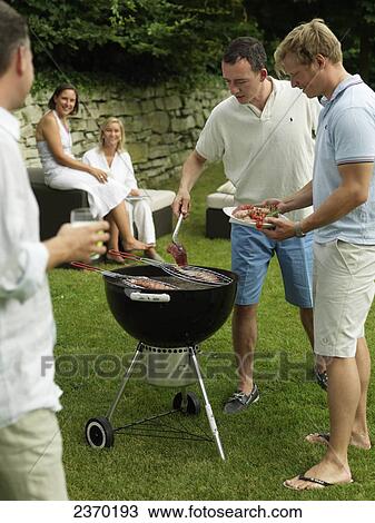 Two men preparing fish on barbeque grill in garden View Large Photo Image Stock Image - Two men preparing fish on barbeque grill in garden . Fotosearch