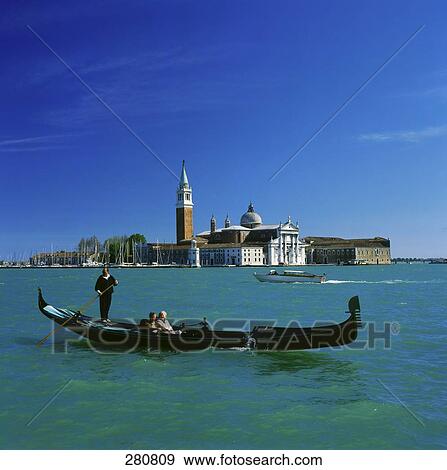 Stock Photo - Two people sailing in gondola, Venice, Italy . Fotosearch