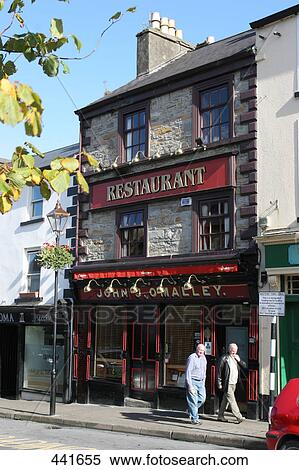 Stock Photography - Two people walking in front of restaurant, Bridge Street, Republic of Ireland . Fotosearch