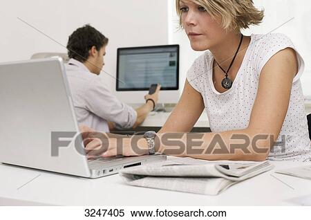 Two teenager using laptop, mobile phone and desktop computer, horizontal format View Large Photo Image Stock Photography - Two teenager using laptop, mobile phone and desktop computer, horizontal format . Fotosearch