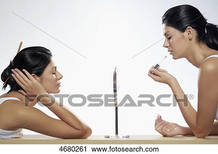 Two young women making up View Large Photo Image Stock Image - Two young women making up . Fotosearch