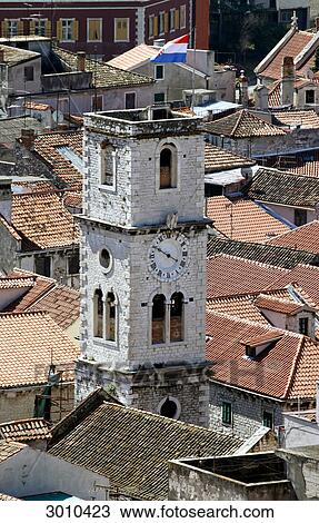 Stock Image - View to an old tower and the rooftops of the old quarter of Sibenik, Croatia, elevated view . Fotosearch