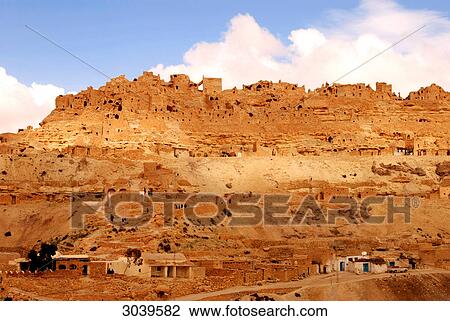 Stock Image - View to mountain village of Chenini with old dugouts, near Tataouine, Tunisia . Fotosearch