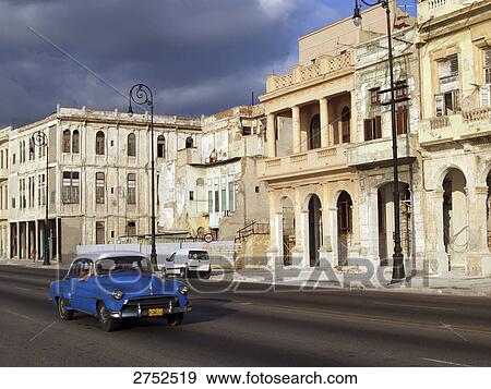 Vintage car traveling on city road View Large Photo Image Stock Photo - Vintage car traveling on city road . Fotosearch