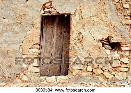Picture - Wall and wooden shed of a traditional granary (ghorfa) at the southtunisian city of Tataouine . Fotosearch
