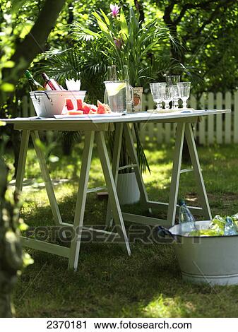 Watermelon slices with beverages and potted plant on table in garden View Large Photo Image Stock Image - Watermelon slices with beverages and potted plant on table in garden . Fotosearch