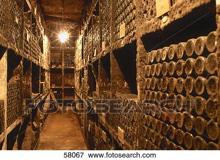 Stock Photo - Wine bottles in dusty cellar . Fotosearch