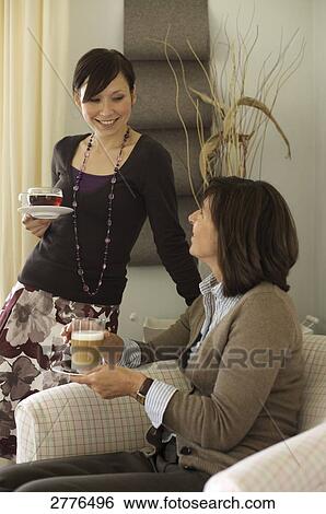 Woman and her daughter looking at each other View Large Photo Image Stock Photograph - Woman and her daughter looking at each other . Fotosearch