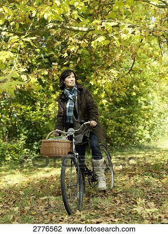 woman on a bicycle, full shot View Large Photo Image Stock Image - woman on a bicycle, full shot . Fotosearch