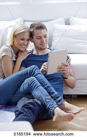 Picture - Young couple with ipad . Fotosearch