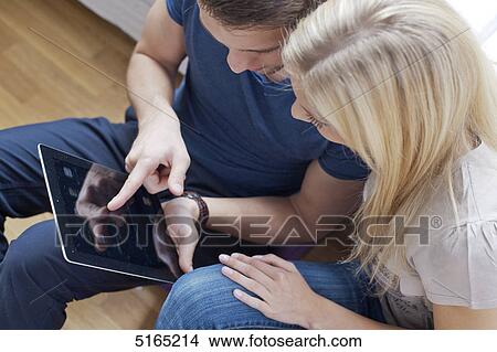 Picture - Young couple with ipad . Fotosearch