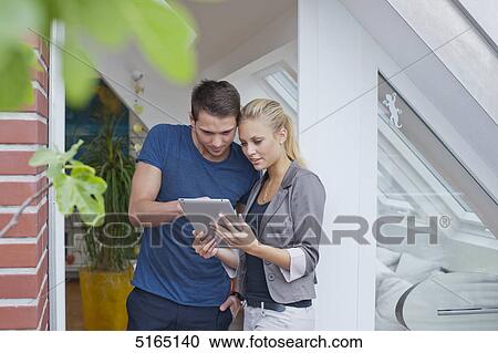 Stock Image - Young couple with ipad . Fotosearch