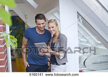 Stock Image - Young couple with ipad . Fotosearch
