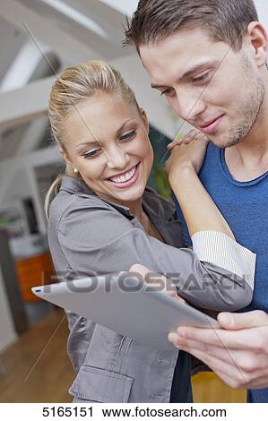 Stock Image - Young couple with ipad . Fotosearch
