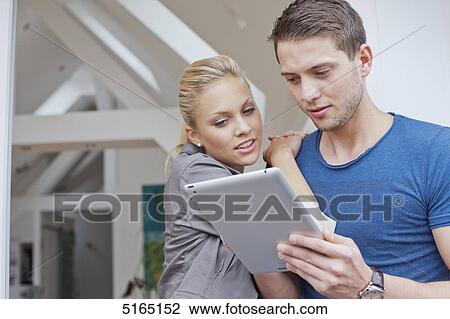 Stock Image - Young couple with ipad . Fotosearch