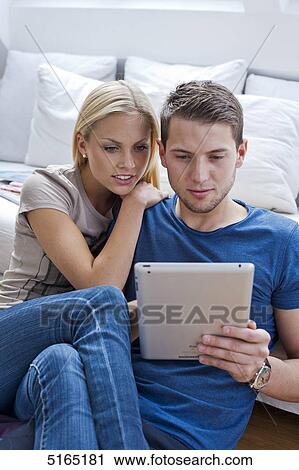 Stock Image - Young couple with ipad . Fotosearch