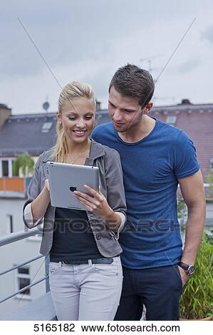Young couple with ipad View Large Photo Image Stock Image - Young couple with ipad . Fotosearch
