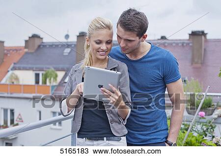 Stock Image - Young couple with ipad . Fotosearch
