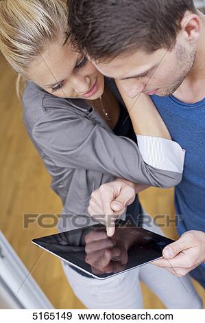 Young couple with ipad View Large Photo Image Stock Photo - Young couple with ipad . Fotosearch