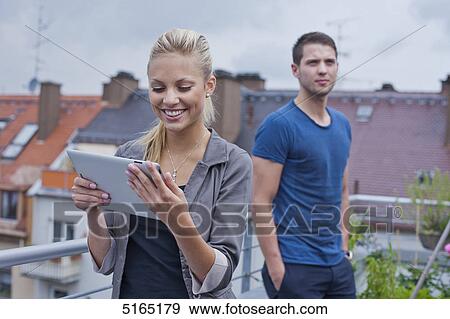 Young couple with ipad View Large Photo Image Stock Photo - Young couple with ipad . Fotosearch