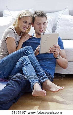 Stock Photo - Young couple with ipad . Fotosearch