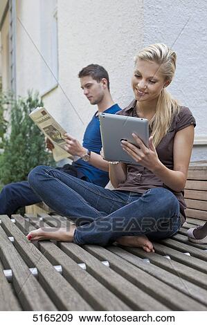 Stock Photo - Young couple with ipad . Fotosearch