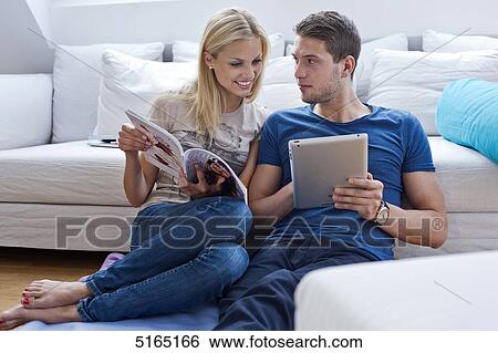 Stock Photograph - Young couple with ipad . Fotosearch