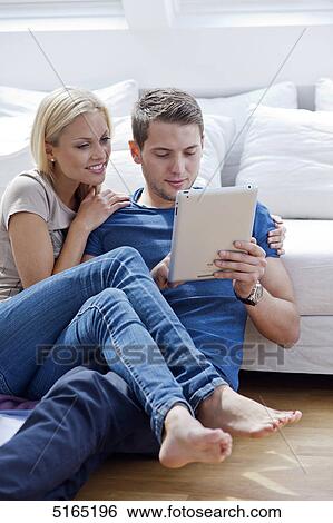 Stock Photograph - Young couple with ipad . Fotosearch